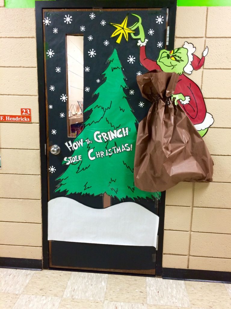 Grinch-themed front door decorations Grinch Lives Here doormat, Grinch-head wreath, and Who-ville mailbox